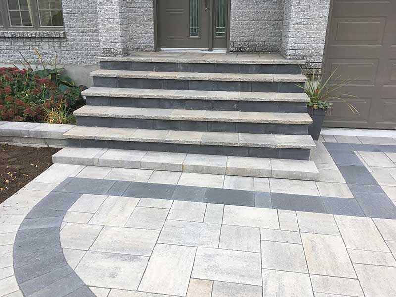 Driveway and matching stairs with light grey and black pavers