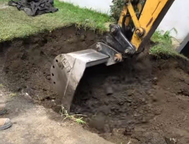 Machine excavating soil